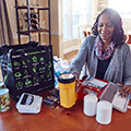 Woman sitting at table creating an emergency outage kit. 